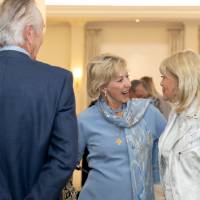 Two women greeting each other at event